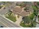 Aerial view of a well-maintained home featuring manicured lawns, mature trees, and a charming walkway leading to the entrance at 7106 S Kendall Blvd, Littleton, CO 80128