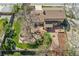 An aerial view showcases the home's expansive backyard, featuring a patio, lush lawn, water feature, and mature trees at 7106 S Kendall Blvd, Littleton, CO 80128