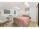 Basement bedroom with a comfortable bed, desk, and ample natural light at 7106 S Kendall Blvd, Littleton, CO 80128