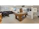 Finished basement with a pool table, exercise equipment, and entertainment area at 7106 S Kendall Blvd, Littleton, CO 80128
