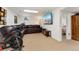Finished basement with an entertainment area, exercise equipment, and a cozy living space at 7106 S Kendall Blvd, Littleton, CO 80128
