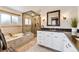 Luxurious bathroom with a soaking tub, glass-enclosed shower, and dual vanity sinks at 7106 S Kendall Blvd, Littleton, CO 80128
