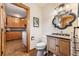 Charming powder room with rustic wood accents and a decorative mirror, adjacent to the laundry area at 7106 S Kendall Blvd, Littleton, CO 80128