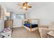 Cozy bedroom featuring a four-poster bed, neutral colors, and a ceiling fan at 7106 S Kendall Blvd, Littleton, CO 80128