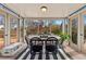 Bright dining room featuring a large window overlooking the landscaped backyard and a modern black and white striped rug at 7106 S Kendall Blvd, Littleton, CO 80128