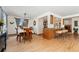 Open-concept dining room featuring hardwood floors, natural light, and a seamless flow into the kitchen area at 7106 S Kendall Blvd, Littleton, CO 80128