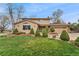 Charming two-story home featuring a manicured front yard and a classic architectural design at 7106 S Kendall Blvd, Littleton, CO 80128