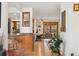 Open hallway with hardwood floors, leading to a dining area and a view of the backyard at 7106 S Kendall Blvd, Littleton, CO 80128