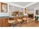 Kitchen island with counter seating, wood detailing, and an open design that connects to the adjacent living and kitchen areas at 7106 S Kendall Blvd, Littleton, CO 80128