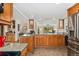Spacious kitchen featuring granite countertops, wood cabinetry, a wine rack, and stainless steel appliances for a modern touch at 7106 S Kendall Blvd, Littleton, CO 80128