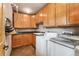 Functional laundry room with ample cabinet space, a utility sink, and modern washer and dryer units at 7106 S Kendall Blvd, Littleton, CO 80128