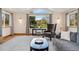 Cozy living room featuring a vaulted ceiling, large windows, and comfortable seating at 7106 S Kendall Blvd, Littleton, CO 80128