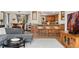 Open-concept living room featuring a breakfast bar, hardwood floors, and comfortable seating at 7106 S Kendall Blvd, Littleton, CO 80128