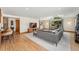 Bright living room with vaulted ceilings, hardwood floors, and large windows overlooking the backyard at 7106 S Kendall Blvd, Littleton, CO 80128