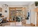 Living space with an open doorway to an outdoor dining area, desk, and built-in storage off of an interior living space at 7106 S Kendall Blvd, Littleton, CO 80128