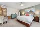 Spacious main bedroom featuring a queen-size bed, ensuite bathroom, and large windows with natural light at 7106 S Kendall Blvd, Littleton, CO 80128