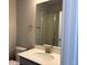 Bathroom featuring a vanity, white countertop, and glass-enclosed shower at 1783 Jennifer St, Brighton, CO 80601