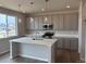 Kitchen featuring an island, pendant lighting, stainless steel appliances, and plenty of cabinet space at 1783 Jennifer St, Brighton, CO 80601