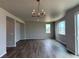 Living room featuring durable plank flooring and light fixture at 1783 Jennifer St, Brighton, CO 80601