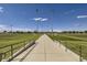 View down a walkway of several soccer and sports fields with bright green grass and clear blue skies at 2126 S Haleyville Way, Aurora, CO 80018