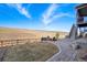 This is a nicely landscaped backyard with a stone patio, a firepit, and mountain views in the background at 17829 W 95Th Pl, Arvada, CO 80007