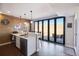 Basement bar features wood plank accent wall, pendant lights, and doors to a patio at 17829 W 95Th Pl, Arvada, CO 80007