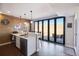 Basement bar featuring granite countertops, beverage fridge, and a folding glass doors opening to the outdoors at 17829 W 95Th Pl, Arvada, CO 80007