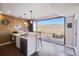 Basement bar with granite countertops, beverage fridge, beer tap, and an expansive view through folding glass doors at 17829 W 95Th Pl, Arvada, CO 80007