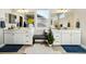Bright bathroom with dual sinks, white cabinets, and elegant decorative touches at 17829 W 95Th Pl, Arvada, CO 80007