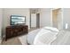 Comfortable bedroom features a TV on a wooden console and a cozy, striped bed at 17829 W 95Th Pl, Arvada, CO 80007