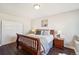Comfortable bedroom featuring a wooden bed frame, soft lighting, and an inviting ambiance at 17829 W 95Th Pl, Arvada, CO 80007