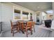 Charming covered patio with wooden furniture, providing a relaxing outdoor dining space at 17829 W 95Th Pl, Arvada, CO 80007