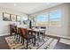 Dining room with modern table, chairs, and a large window providing natural light and a beautiful view at 17829 W 95Th Pl, Arvada, CO 80007