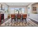 Elegant dining room featuring modern decor, hardwood floors, and large windows with scenic views at 17829 W 95Th Pl, Arvada, CO 80007