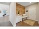 Inviting entryway featuring wood accent wall, bench, and convenient storage cabinets at 17829 W 95Th Pl, Arvada, CO 80007