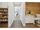 Welcoming entryway with wood accent wall, storage cabinets, bench, and view to the living room at 17829 W 95Th Pl, Arvada, CO 80007