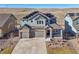 The home is shown with solar panels, a two-car garage, professional landscaping, and a mountain view at 17829 W 95Th Pl, Arvada, CO 80007