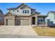 Charming two-story home with a three-car garage, stone accents and a cozy front porch at 17829 W 95Th Pl, Arvada, CO 80007