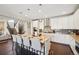 Open-concept kitchen showcasing modern cabinetry, stainless appliances, granite counters, and island with seating at 17829 W 95Th Pl, Arvada, CO 80007