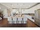 Spacious kitchen with a large center island, stainless appliances, and stylish pendant lighting fixtures at 17829 W 95Th Pl, Arvada, CO 80007