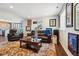 Cozy living room featuring leather furniture, a decorative rug, and a window with natural light at 17829 W 95Th Pl, Arvada, CO 80007