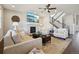 Cozy living room with a fireplace, large TV, comfortable seating, and staircase leading to the upper floor at 17829 W 95Th Pl, Arvada, CO 80007