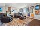 Cozy living room features leather furniture, a patterned rug, and framed art on the walls at 17829 W 95Th Pl, Arvada, CO 80007