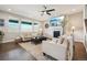 Inviting living room with ample natural light, a fireplace, comfortable seating, and views of the outside landscape at 17829 W 95Th Pl, Arvada, CO 80007