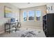 Sunlit office with a desk, chair, a large window, and a stylish rug at 17829 W 95Th Pl, Arvada, CO 80007