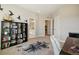 Versatile room with a modern desk, a bookcase, and a peek into the adjacent bathroom and laundry room at 17829 W 95Th Pl, Arvada, CO 80007