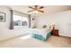 Bright bedroom with large window, ceiling fan and comfortable bed at 3855 S Monaco St # 170, Denver, CO 80237