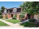 Brick townhouse exterior with well-maintained landscaping and walkway at 3855 S Monaco St # 170, Denver, CO 80237