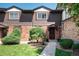 Attractive townhome with a brick and wood exterior, featuring a manicured lawn at 3855 S Monaco St # 170, Denver, CO 80237