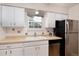 Neat kitchen features white cabinets and stainless steel appliances at 3855 S Monaco St # 170, Denver, CO 80237